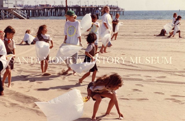 Girl Scouts and Brownies clean up trash on the beach near Santa Monica Pier, 1990