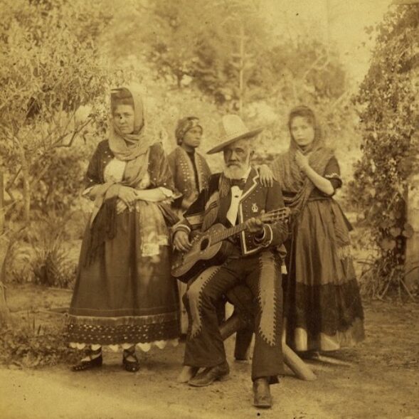 sepia toned photograph of a family outdoors in fancy dress in May 18, 1887