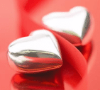 two silver hearts on red background