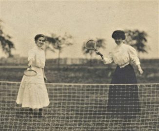 Two women hold rackets on a grass tennis court.Santa Monica History Museum Collection (36.2.3016)