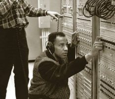 Professor Hal Walker next to audio equipment