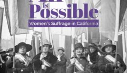 Women suffragists marching in street