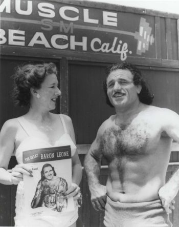 At Muscle Beach, Baron Michele Leone with a woman hold a flyer with his image on it.