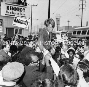 Robert Kennedy shaking hands in a crowd of people
