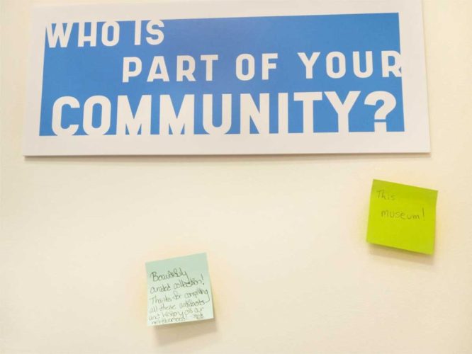 post-its on wall next to a question: Who is part of your community?
