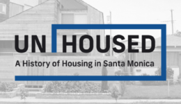 Black and white image of homes with exhibition text UNHOUSED