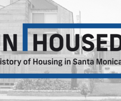 Black and white image of homes with exhibition text UNHOUSED