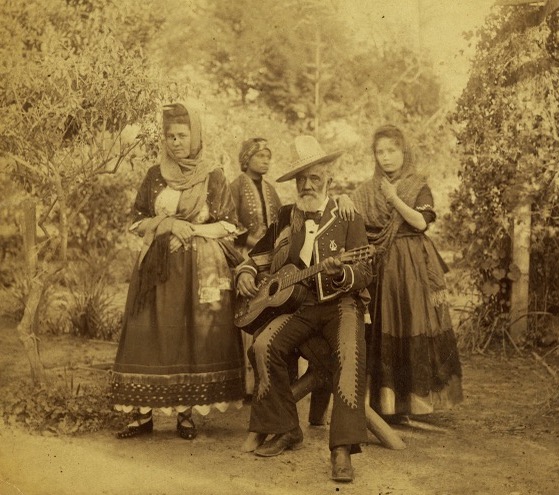 sepia toned photograph of a family outdoors in fancy dress in May 18, 1887