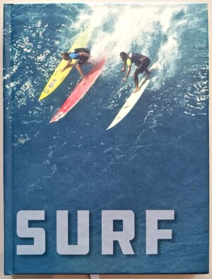 cover of a notebook journal - surfers surfing a wave