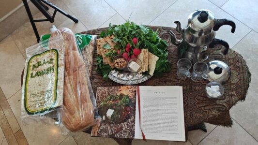 Table display of lavash bread, book, crackers and tea