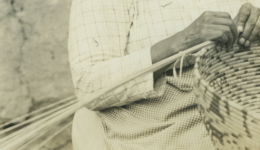 Person weaving a basket